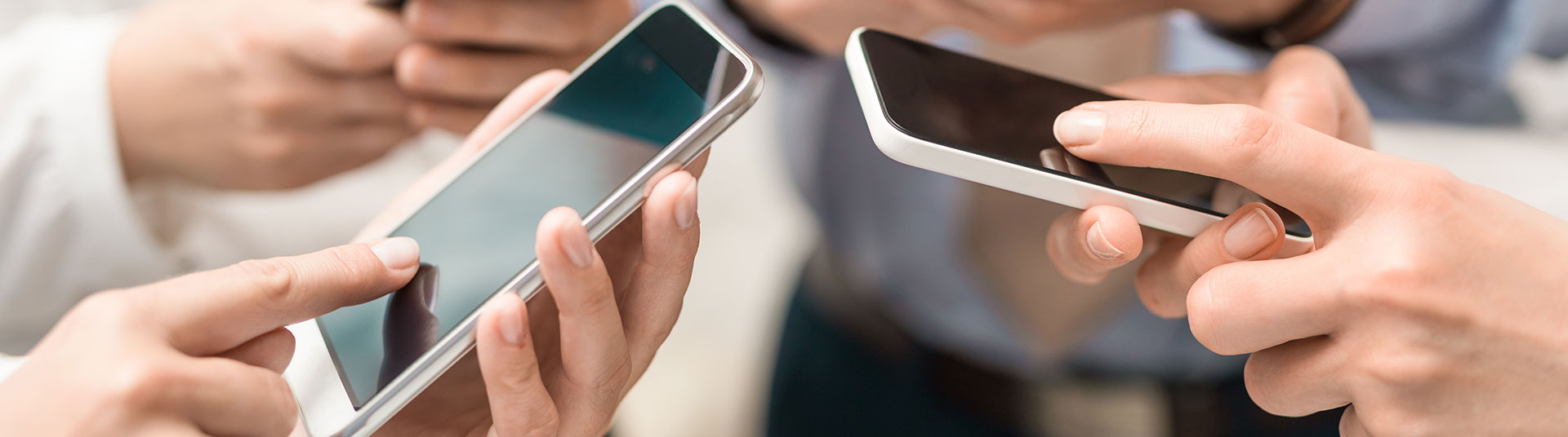 Various people holding smartphones